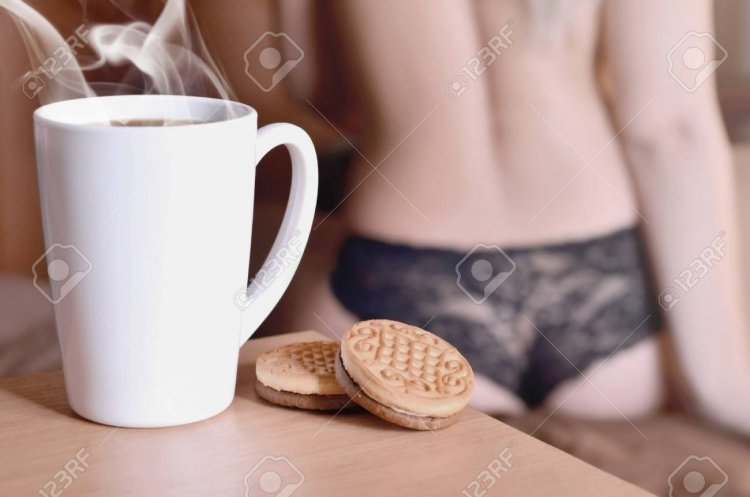 96481701-a-cup-of-hot-coffee-and-round-cookies-with-a-silhouette-of-a-sexy-girl-in-black-under...jpg