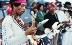 Jimi Hendrix playing his guitar during his set at_.jpg